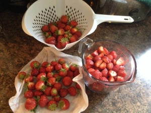 Prepping the strawberries, washed and cut into smaller pieces before crushing them 
